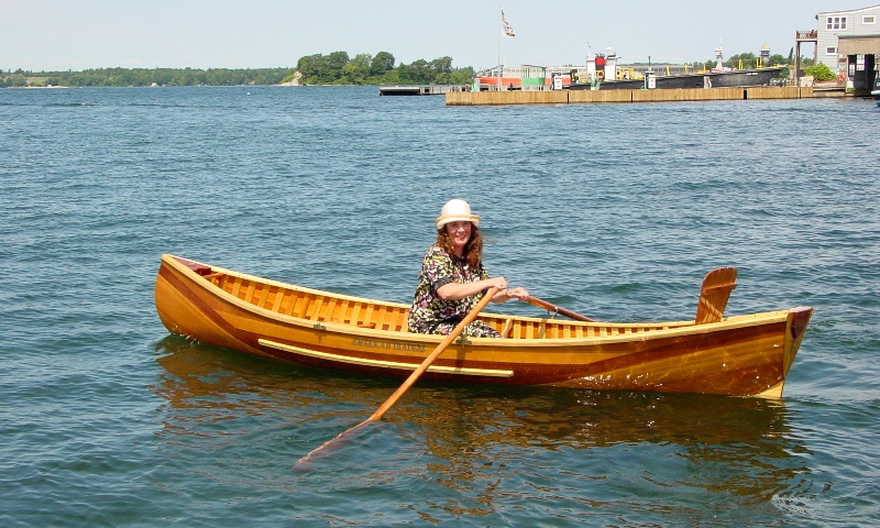 Skylark rowing canoe, Lady in 1920's dress out in Clayton New York